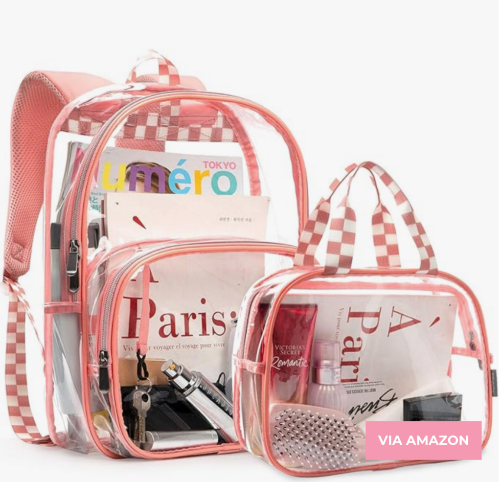 A clear backpack and matching clear handbag with checkered pink and white straps, containing various items like magazines, a hairbrush, perfume, a pen, and makeup. "Via Amazon" label in the corner.